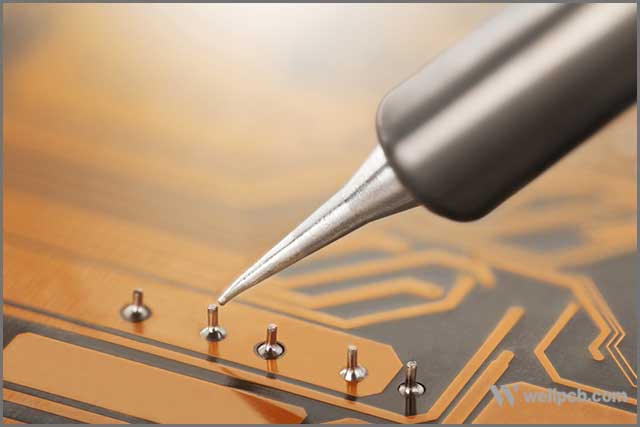 A soldering iron is soldering a component on PCB.jpg