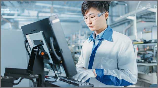 Engineers in Asian factories use computers for PCB programming.jpg