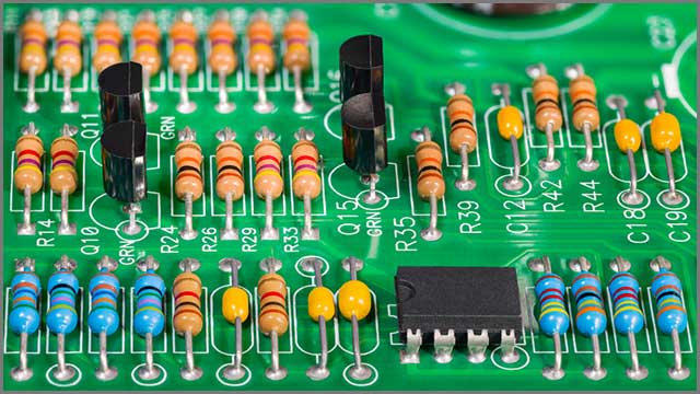 Integrated circuit, capacitors, and other parts on a PCB.jpg