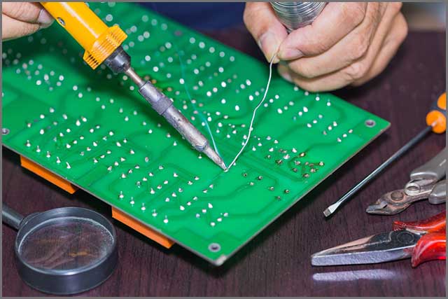 Soldering on circuit board with soldering iron and solder in board repairing.jpg