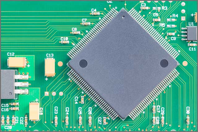 Surface mount technology (SMT) microchip on plated through-hole PCB.jpg