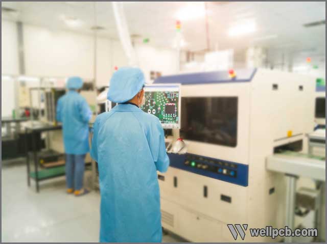 Cheaper labor cost in China than Europe and America, Rear view of worker supervising the AOI of a printed circuit board.jpg