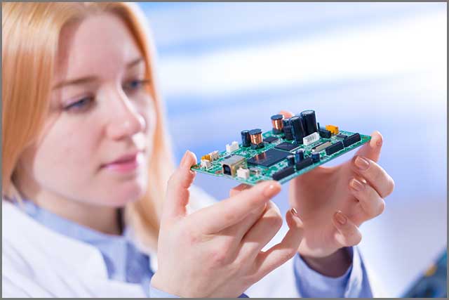 A woman looking at a PCB device.jpg