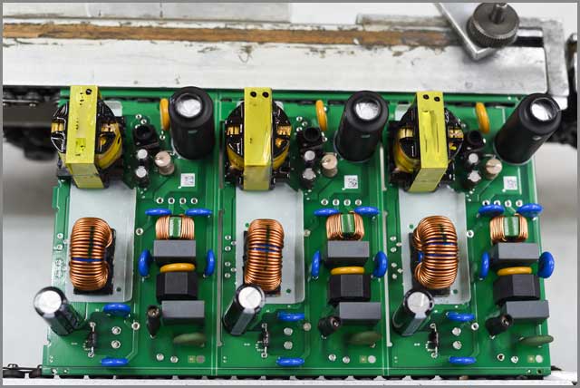 Top view of the printing circuit board after placement of through-hole components on it in an electronics manufacturing plant..jpg