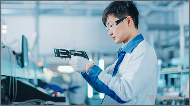 Quality Control Engineer Checks Electronic Printed Circuit Board it for Damages.jpg