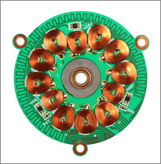 Parts of a DC motor etched on a circular printed circuit board.jpg