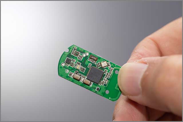 A microchip held in a male hand.jpg
