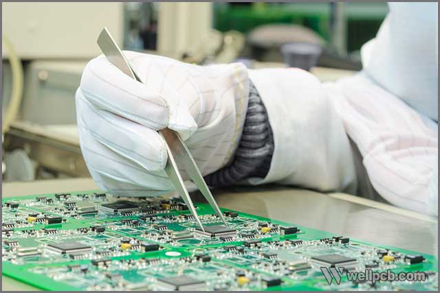 an expert inspecting any irregular patches on PCB.jpg