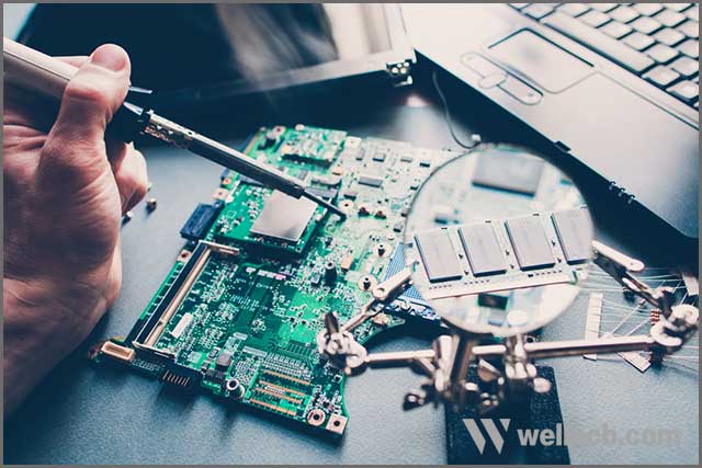 Technician repairing pcb layout with soldering iron.jpg