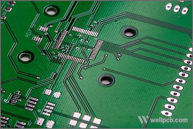 Printed green computer circuit board with many electrical components.jpg