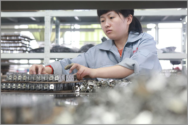 A Chinese engineer working on rigid-flex PCB assembly