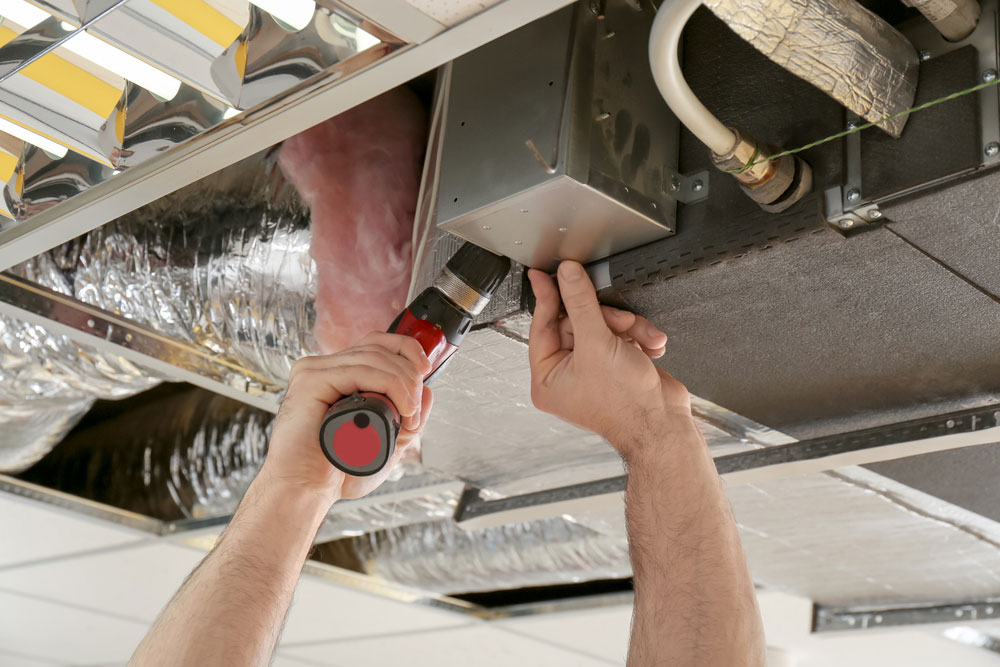 (Technician installing an electronic component)