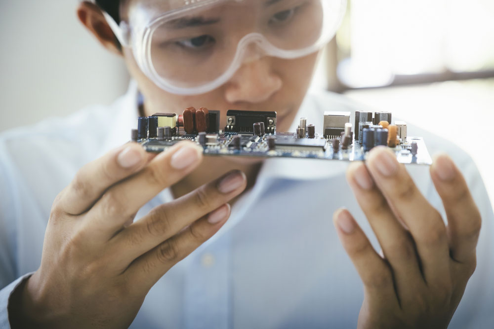 BJT Transistors:A Technician Checking an Electronic Circuit Board