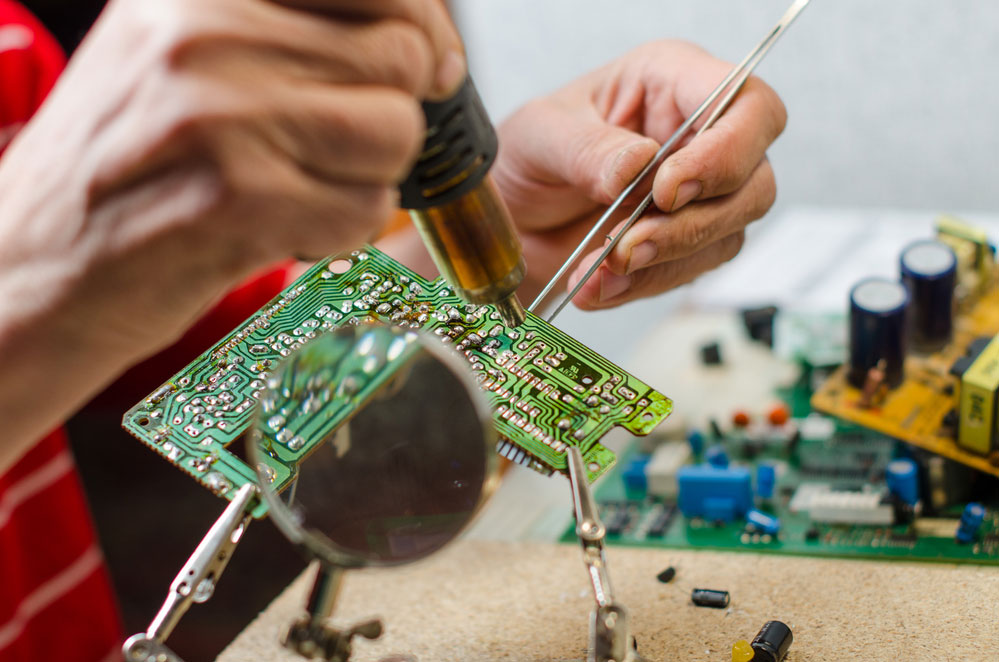 Engineer soldering a microcircuit