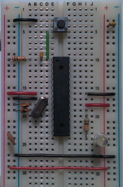 An ATmega328P chip attached to a breadboard