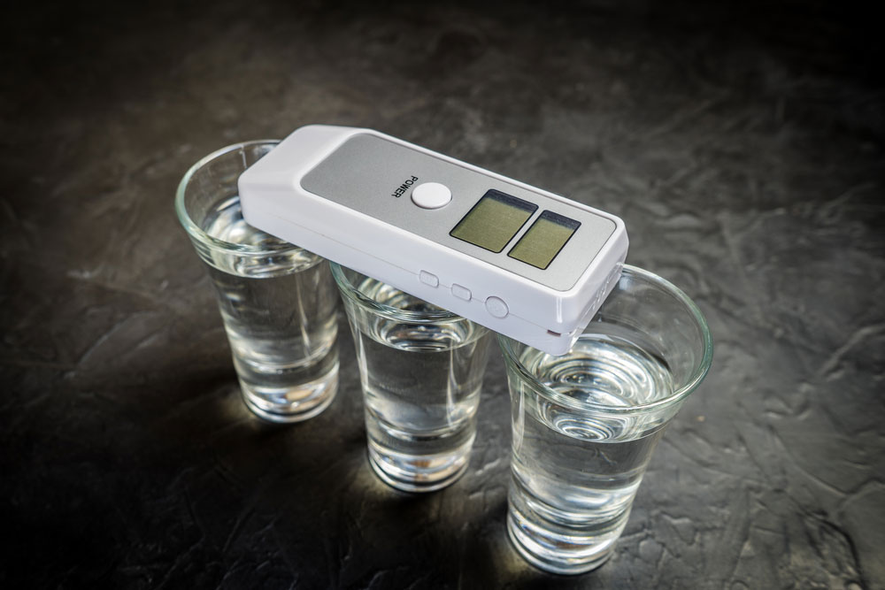 A Breath analyzer and alcohol in glasses