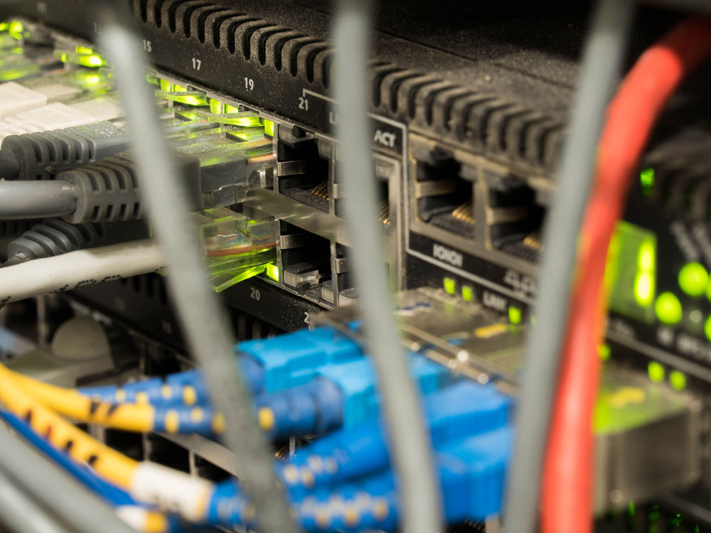 Ethernet cables connected to internet switch in a server rack