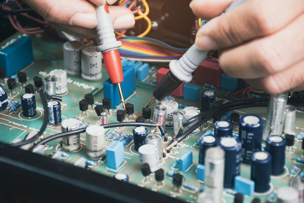 Electrician checking transistor voltage