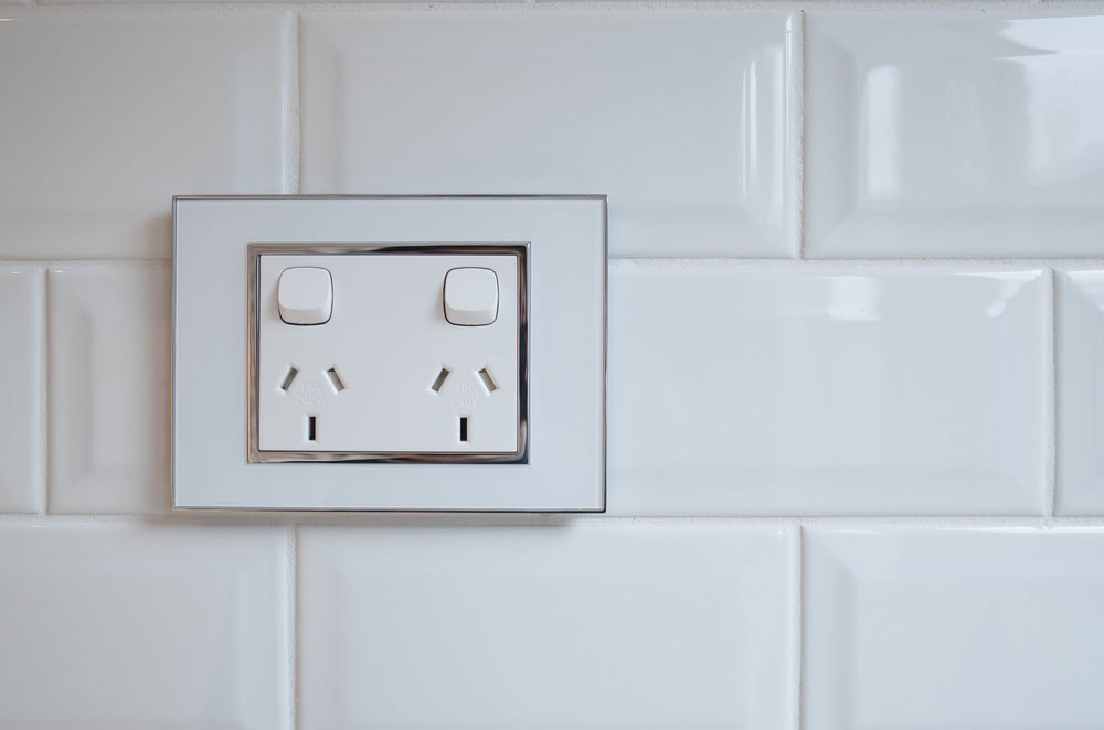 An electrical socket plate outlet on a wall