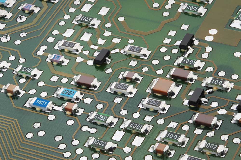 Surface-mount components on electronic circuit board close-up