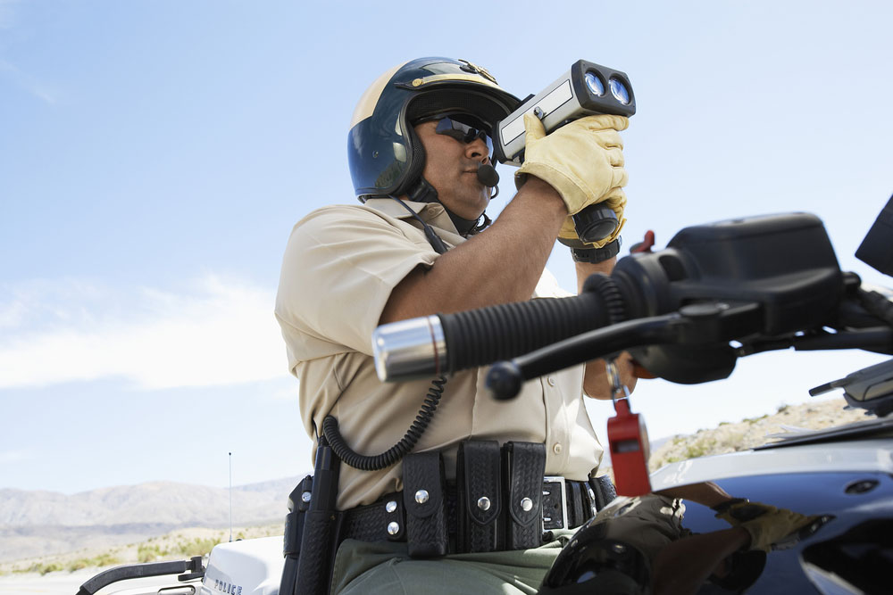 A cop using a radar gun