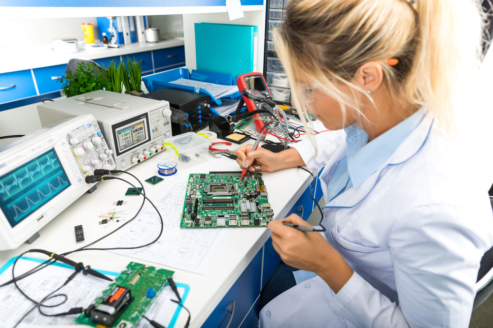 Woman working on a PCB
