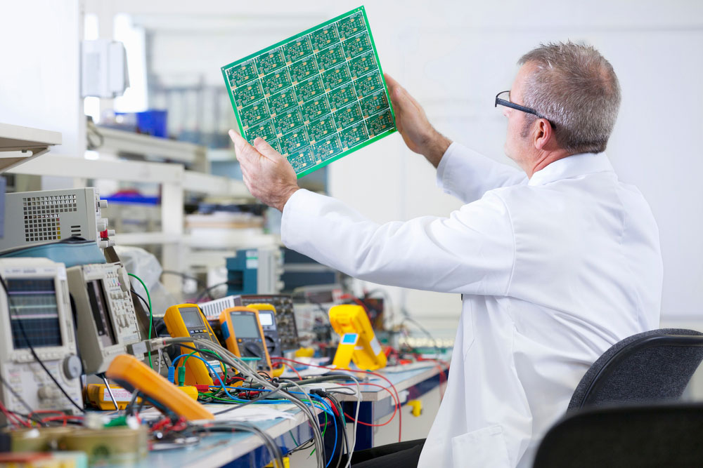 An engineer inspecting a PCB