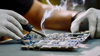 Man soldering a PCB